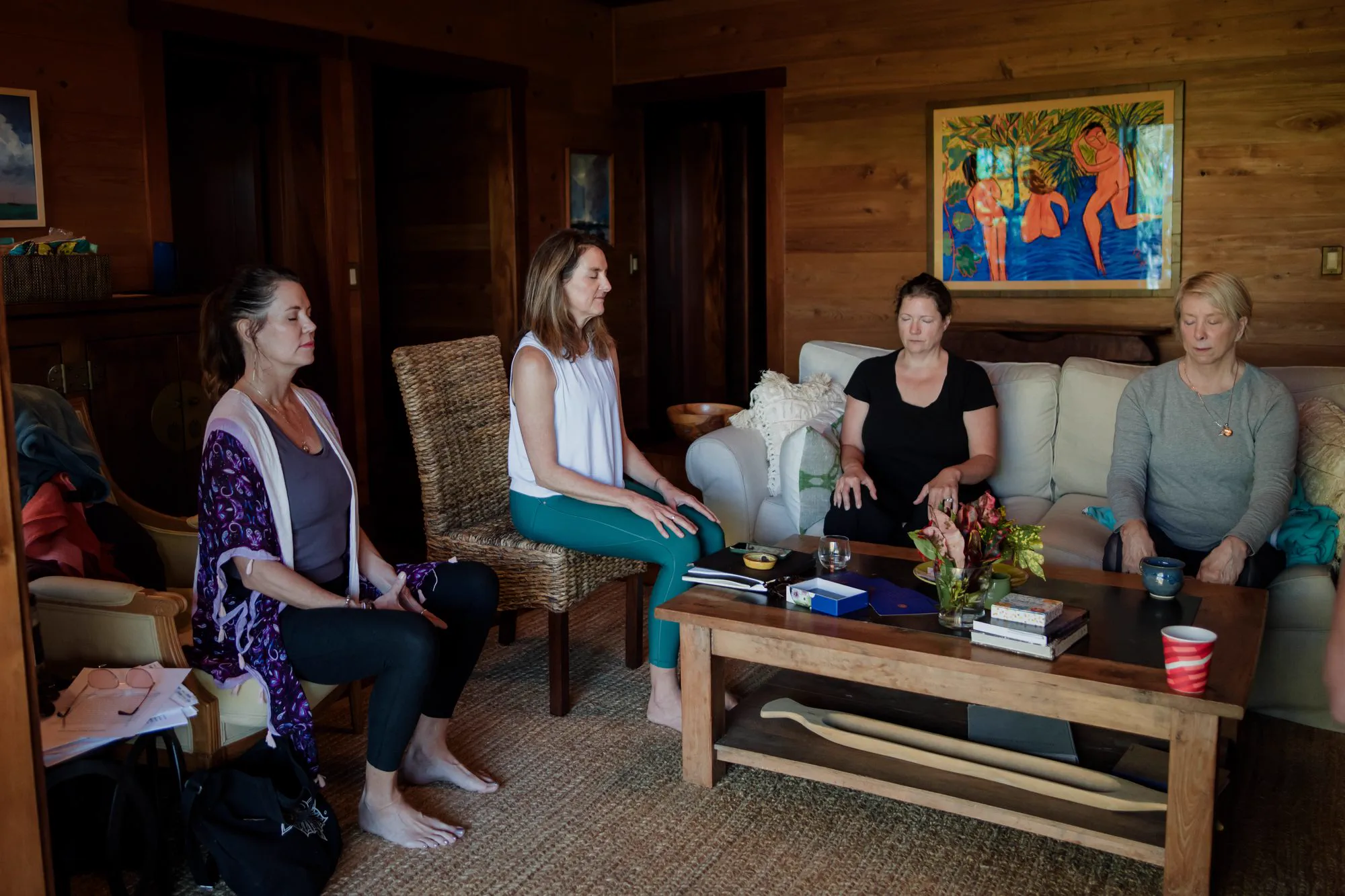 Guests gathered in a circle in the living room, in easy conversation.